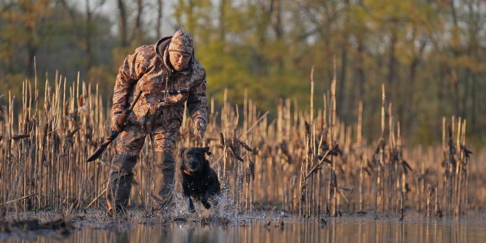 Hunter dressed in camo for early season archery deer hunting